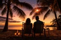 Christmas on the tropical coast, New Year mood. Rear view of young happy couple in love sitting on the chairs on the beach and