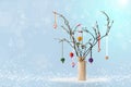 Christmas twig tree and baubles. Snowy blue bokeh background Royalty Free Stock Photo