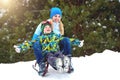 Mother and son ride on sleigh .Child play in snowy forest. Outdoor winter fun for family Christmas vacation. Royalty Free Stock Photo