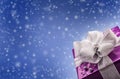 Christmas or Valentine's purple gift with silver ribbon abstract blue background Royalty Free Stock Photo