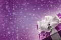 Christmas or Valentine's purple gift with silver ribbon abstract purple background