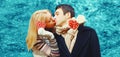 Christmas, valentines day, winter and people concept - happy young couple in love kissing with red hearts on snowy winter Royalty Free Stock Photo