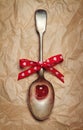 Christmas valentines spoon with cherry and red bow Royalty Free Stock Photo