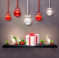 New year festive composition with hanging christmas balls gift box holly berries and round candles realistic