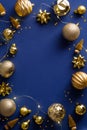Christmas vertical banner design. Frame made of golden Christmas decorations, balls, tinsel on dark blue background. Xmas frame Royalty Free Stock Photo