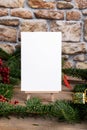 Christmas vertical card mockup template with fir twigs and Christmas decoration on wooden background Royalty Free Stock Photo