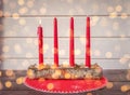 Christmas vintage card. First Advent. Four candles. One red burning candle in a beautiful glass candlestick. Christmas holiday in Royalty Free Stock Photo