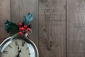 Christmas vintage clock. Holly berries and wood. Copy space. Royalty Free Stock Photo