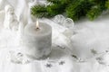 Christmas vintage decoration with burning grey candle, fir branch and angel statue