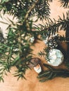 Christmas vintage glass baubles and mushroom toys on rustic wooden table under fir branches. Preparation for winter holidays. Royalty Free Stock Photo