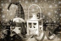 Christmas vintage lantern in snow at wooden background in sepia