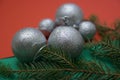 Christmas wallpaper with silver tree balls and conifer branches on a red-green background, Christmas decoration Royalty Free Stock Photo