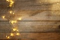 Christmas warm gold garland lights on wooden rustic background