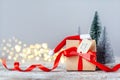 Christmas white box or present with red ribbon from Secret Danta with santa hat and xmas trees. Happy holiday concept Royalty Free Stock Photo