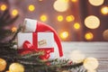 Christmas white box or present with red ribbon for secret santa with santa hat on wooden table Royalty Free Stock Photo