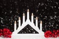 Christmas white candle lights bridge and red berries of left and right site on dark background Royalty Free Stock Photo