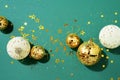 Christmas white and gold decorations, mirror disco balls, star sparkles over green background. Flat lay, top view. Minimal New Royalty Free Stock Photo