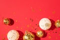 Christmas white and gold decorations, mirror disco balls, star sparkles over red background. Flat lay, top view. Minimal New year Royalty Free Stock Photo