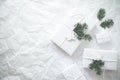 Christmas white handmade gift boxes on white crumpled background top view. Merry Christmas greeting card, frame. Royalty Free Stock Photo