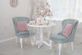 Christmas white interior of dinning room with table set for christmas dinner. Kitchen with Xmas decorations. Christmas table and c Royalty Free Stock Photo