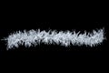 Christmas white tinsel on black background. View from above Royalty Free Stock Photo