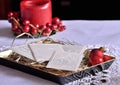 Christmas white wafer and candle on the table. Oplatek