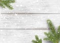 Christmas white wooden background with holiday fir tree branches, pine cone and falling shiny snow. Flat lay, Top view with copy s Royalty Free Stock Photo