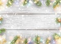 Christmas white wooden background with holiday fir tree branches, pine cone, light garland, bokeh, falling shiny snow. Royalty Free Stock Photo