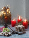 Christmas window. Candles, garlands, Christmas decoration, gingerbread cookie. Close-up, it is raining. Vertical orientation Royalty Free Stock Photo