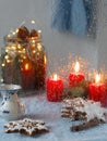 Christmas window. Candles, garlands, Christmas decoration, gingerbread cookie. Close-up, it is raining. Vertical orientation. Royalty Free Stock Photo