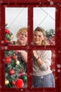 Christmas through the window. Christmas wonder. Two girlfriends exchanging christmas presents. Royalty Free Stock Photo