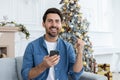 Christmas winner portrait, man celebrating victory and good achievement results, winner looking at camera and smiling