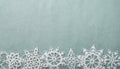 Christmas or winter background blue rough crafts paper with handmade crochet snowflakes. Royalty Free Stock Photo