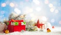 Christmas winter background with gift box, Christmas baubles and fir tree branches on snow Royalty Free Stock Photo