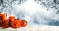 Christmas winter background. Red candles and baubles. Spruce and pine branches over the board covered with snow. Royalty Free Stock Photo