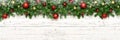 Christmas winter banner with snow and snowflake on white wooden background fir tree branches and new year toy ball or bauble. Royalty Free Stock Photo