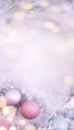 Christmas winter blurred background. Vertical Christmas background in soft pink color with space for text. Decorations and lights Royalty Free Stock Photo