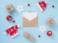 Christmas or winter composition with envelope and red decorations on pastel blue background. New year concept. Royalty Free Stock Photo