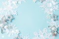 Christmas or winter composition. Frame made of paper cut snowflakes and silver stars on pastel blue background. Christmas, winter Royalty Free Stock Photo