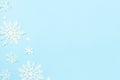 Christmas or winter composition. Snowflakes decoration on blue pastel background. Flat lay, top view, copy space Royalty Free Stock Photo