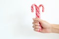 Christmas, winter concept. Holidays, sweets, treats. Man hands holding traditional striped candy cane in shape of bouquet. Male ha Royalty Free Stock Photo