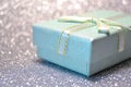 Christmas winter green mint gift box with a little bow in a white background bokeh