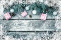 Christmas winter holiday background with gifts boxes with fir branches, pine cones, New Year balls on wooden table. Royalty Free Stock Photo