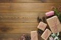 Christmas and winter holidays mock up. Cchristmas gift box with pine cones, fir brances, on brown wood table with copy space.