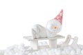 Christmas, winter or New Year composition. Young snowman with red woolen cap laying and sleeping on white wooden sledge. Royalty Free Stock Photo