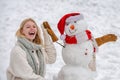 Christmas winter poeple. Greeting snowman. Winter scene with happy people on white snow background. Winter portrait of Royalty Free Stock Photo