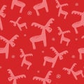 Christmas and winter themed seamless pattern, with reindeers and snowflakes on red background Royalty Free Stock Photo