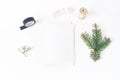 Christmas, winter wedding desktop stationery mock-up scene. Blank greeting card, envelope, black washi tape, silk ribbon Royalty Free Stock Photo