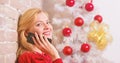 Christmas wishes concept. Woman pretty peaceful dreamy face hold smartphone enjoy mobile phone conversation. Girl near Royalty Free Stock Photo