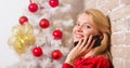 Christmas wishes concept. Woman pretty peaceful dreamy face hold smartphone enjoy mobile phone conversation. Girl near Royalty Free Stock Photo